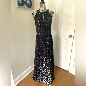 Teri Jon black with white polka dots dress. Beautiful sequin detail at neck.